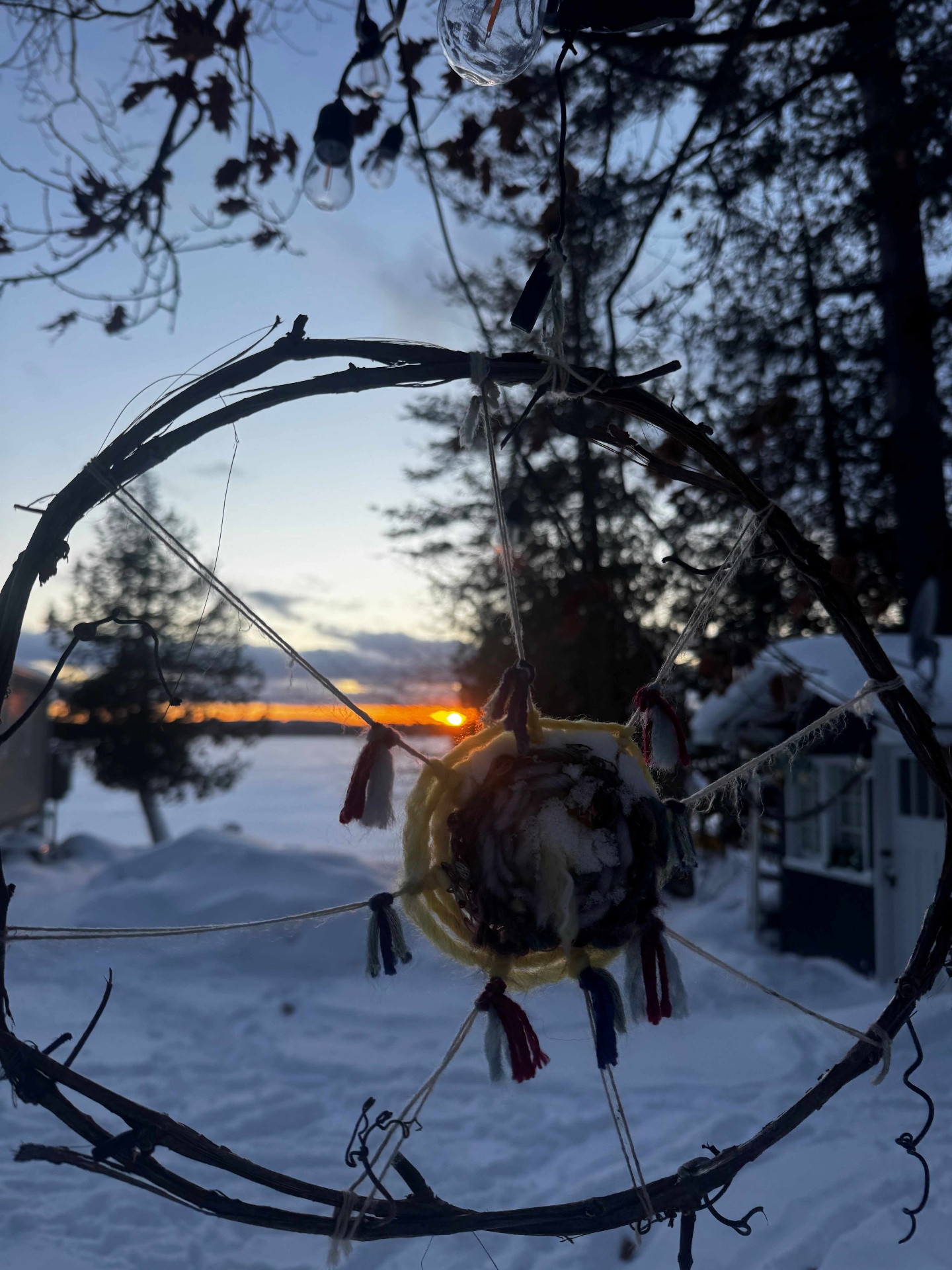 Winter dreamcatcher at dusk over a frozen lake